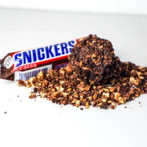A symphony of chocolate, caramel, peanuts, and nougat, all wrapped up in a decadent dark chocolate shell. It's a Snickers bar, reimagined.